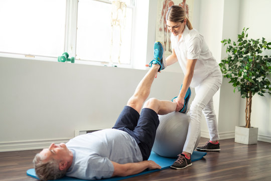 A Modern rehabilitation physiotherapy worker with senior client