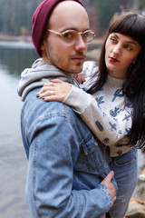 Romantic newlywed couple hugging near blue lake