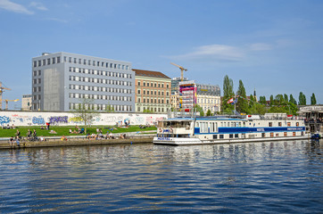 Banks of the river Spree with the East Side Gallery, Eastern Comfort Hostel Boat and Floating Lounge in Berlin © laranik