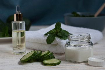 Natural ingredients for homemade cucumber face mask on white wooden background