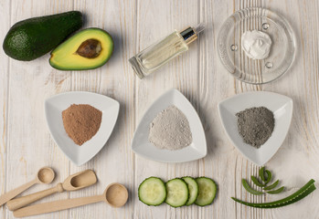 Ingredients for homemade beauty face mask of clay with avocado, cucumber, oil, aloe vera.  DIY cosmetics and spa. Top view
