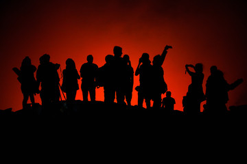 Fototapeta na wymiar Unrecognized Tourists's silhouettes on Erta Ale Volcano edge illuminated with lava. Danakil Depression, Ethiopia, East Africa