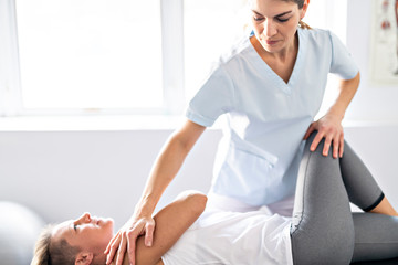 A Modern rehabilitation physiotherapy worker with woman client