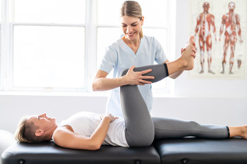 A Modern rehabilitation physiotherapy worker with woman client