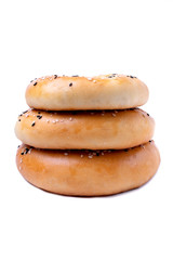 Three bagels sprinkled with sesame seeds. Isolated object