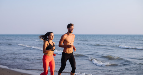 Couple Jogging by the Sea