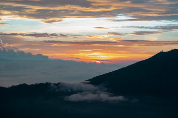 Fototapeta na wymiar Watching sunrise from above the clouds and mist at mount batur in Indonesia. View to live for, amazing world amazing beauty