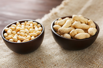 Peanuts in the shell and peeled closeup in a cup