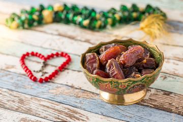 Dates with red shaped rosary on vintage turquoise table side view