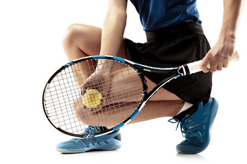 Full length portrait of young woman playing tennis isolated on white background. Healthy lifestyle. The practicing, fitness, sport, exercise concept. The female model in motion or movement