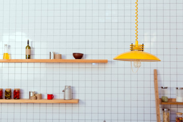 wooden shelves, jars and lamp in kitchen with white tile on background