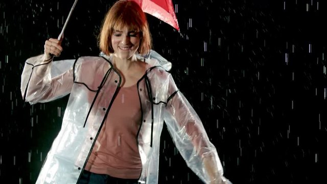 Beautiful woman dancing in the rain. Slow Motion.