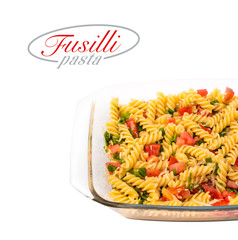 Fusilli paste corkscrew corkscrew shapes on white background with copy space for your design, new packaging. fusilli pasta with vegetables