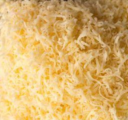grated soft cheese, top view. background texture