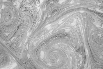 Abstract monochrome marble background. Stains of paint on the surface of the water.