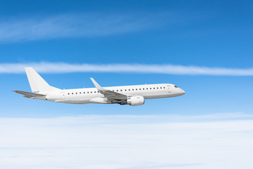 Fototapeta na wymiar Airplane flies in blue sky cloudscape view.