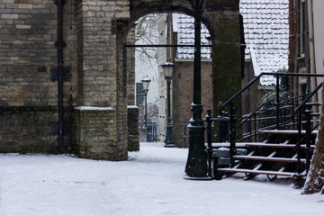 Gouda, South-Holland/The Netherlands - January 22 2019: First real snow in the Netherlands in 2019 a walk through the inner city of Gouda snow covered alleyway
