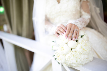 bridal hands on a wedding bouquet