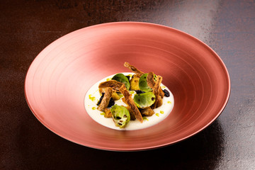 Corn dumplings on cauliflower puree, Brussel sprouts, crunchy potato skins,