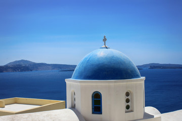 Fototapeta na wymiar Beautiful view of the dome of the church and the sea on the island of Santorini in Greece