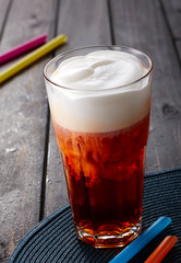 Foam red tea on wooden table