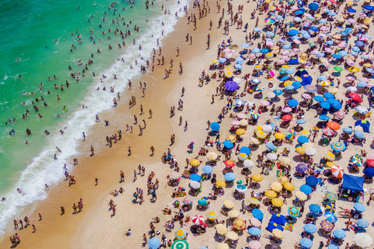 Rio de Janeiro, Brazil, Aerial View of Copacabana Beach Showing Colourful Umbrellas and People Bathing in the Ocean on a Summer Day, Tropical Vacation and Travel Concept - Powered by Adobe