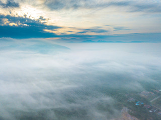 Fototapeta premium Aerial view of mountain and morning mist during sunrise.