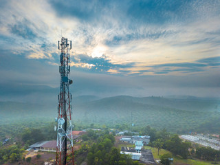 Obraz premium Aerial view of telecommunication tower with sunrise background.