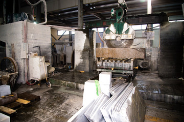 Granite processing in manufacturing. Cutting granite slab with a circular saw. Use of water for...