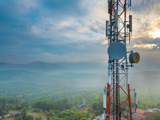 Aerial view of telecommunication tower with sunrise background.
