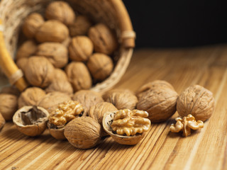 Walnut on a wooden table in a wicker basket