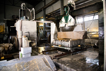 Granite processing in manufacturing. Cutting granite slab with a circular saw. Use of water for cooling. Industrial sawing of granite