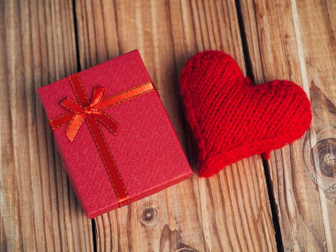 Valentine's day gift and red heart on wooden background