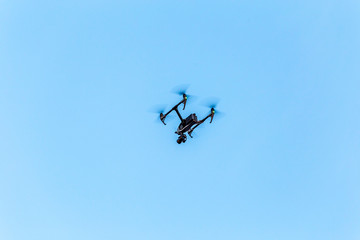 Fototapeta na wymiar Big professional quadcopter in the sky