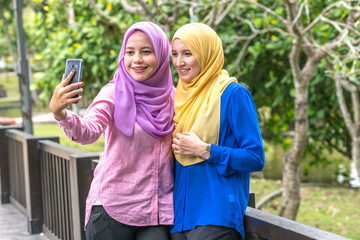veiled teenager with muslimah lifestyle concept at green garden.