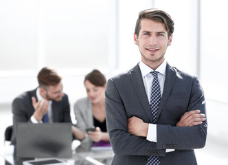 confident businessman standing in the office.