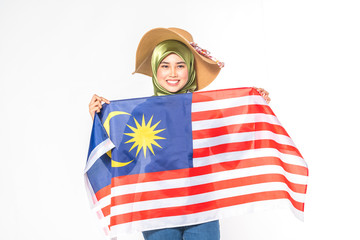 Hijab teenager holding malaysia flag for independence day celebration.