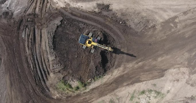 Flying Over Backhoe In Construction Site