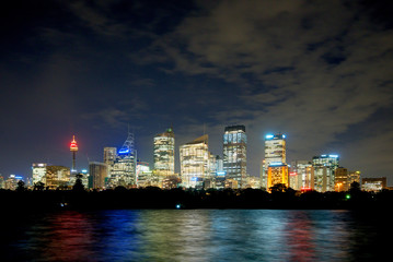 Obraz na płótnie Canvas sydney cbd panorama at night, buildings reflection in water, dark cloudy night sky