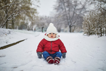 Fototapeta na wymiar Baby girl in stroller in Paris on a day with heavy snow