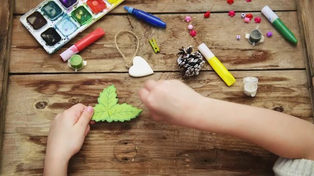 Mother helping her daughter gluing toy. Kid's craft and decoration concept. 