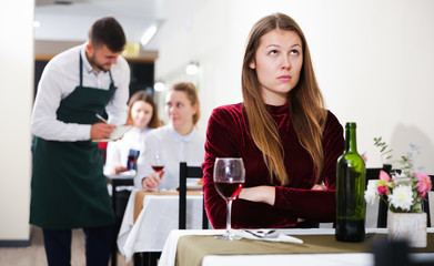 Sad woman is dining in luxury restaurante alone