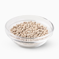 White peppercorns in glass bowl.