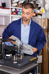 man worker makes print on shirt