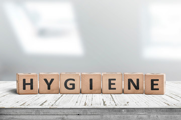 Hygiene sign on a wooden table in a bright bathroom