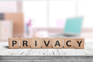 Privacy sign on a wooden table in a bright room