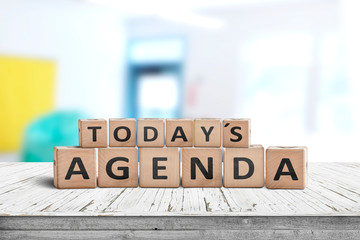 Today's agenda sign on a wooden desk