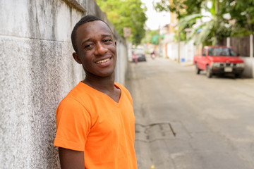 Young happy black African man smiling and looking at camera