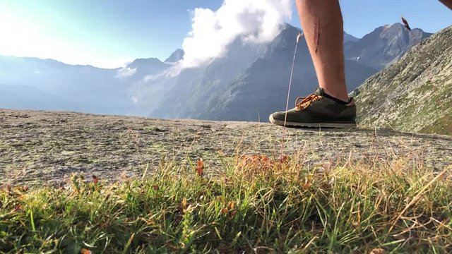 Hiker shoes on a adventure crossing the peak trail of Olpererh&radic;&ordm;tte Zillertal Alps in Austria
(low angle shot) (slow motion shot)