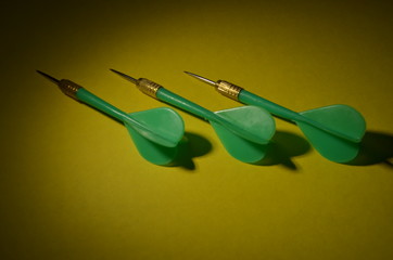 Green darts on a yellow background